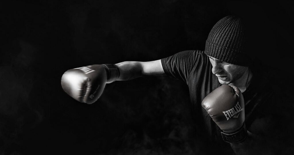 A powerful black and white image of a boxer throwing a punch, showcasing strength and focus.